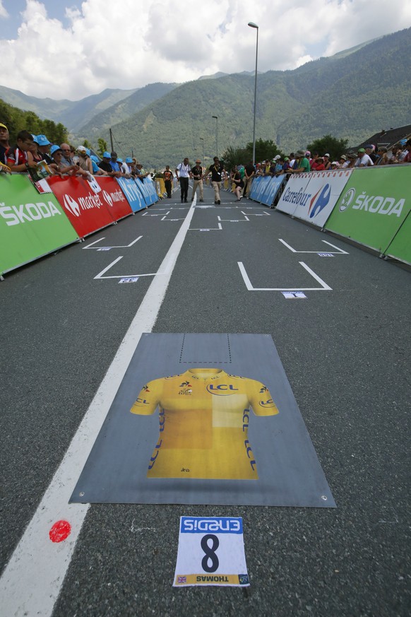 The Formula One-like start grid with overall leader Britain&#039;s Geraint Thomas&#039;s spot marked by the overall leader&#039;s yellow jersey, is seen prior to the seventeenth stage of the Tour de F ...