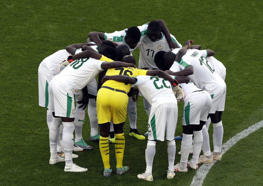 Senegal team embrace prior to the group H match between Japan and Senegal at the 2018 soccer World Cup at the Yekaterinburg Arena in Yekaterinburg , Russia, Sunday, June 24, 2018. (AP Photo/Mark Baker ...