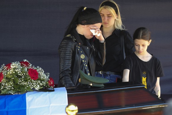 Relatives of Russian Army Sgt. Daniil Dumenko, 35, who was killed in fighting in Ukraine, mourn during a farewell ceremony in his homeland in Volzhsky, Russia, Thursday, May 26, 2022. (AP Photo)