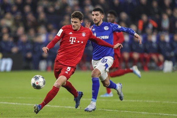 epa08267786 Benjamin Pavard of Bayern Munich (L) and Nassim Boujellab of Schalke 04 (R) in action during the German DFB Cup quarter final match between Schalke 04 and Bayern Munich in Gelsenkirchen, 0 ...