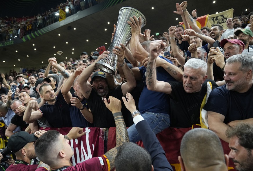 Roma fans celebrate with the trophy after winning the Europa Conference League final soccer match between AS Roma and Feyenoord at National Arena in Tirana, Albania, Wednesday, May 25, 2022. AS Roma w ...