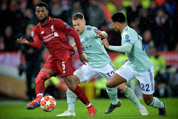 epa07381664 Liverpool&#039;s Georginio Wijnaldum (L) in action against Bayern players Joshua Kimmich (C) and Serge Gnabry (R) during the UEFA Champions League round of 16 first leg soccer match betwee ...