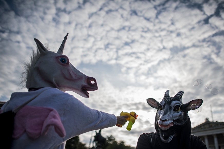 epa06238386 Protestors wear animal masks during a demonstration against a full-face veil ban in Vienna, Austria, 01 October 2017. The new law bans full-face veils in public places from 01 October 2017 ...