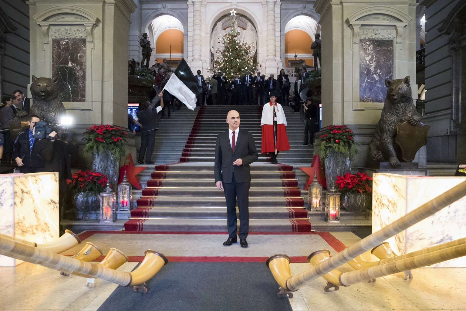 Alphorn blowers play for the newly elected President of the Swiss Confederation Alain Berset, center, in the federal parliament building in Bern, Switzerland, on Wednesday, Dec. 6, 2017. (Peter Klaunz ...