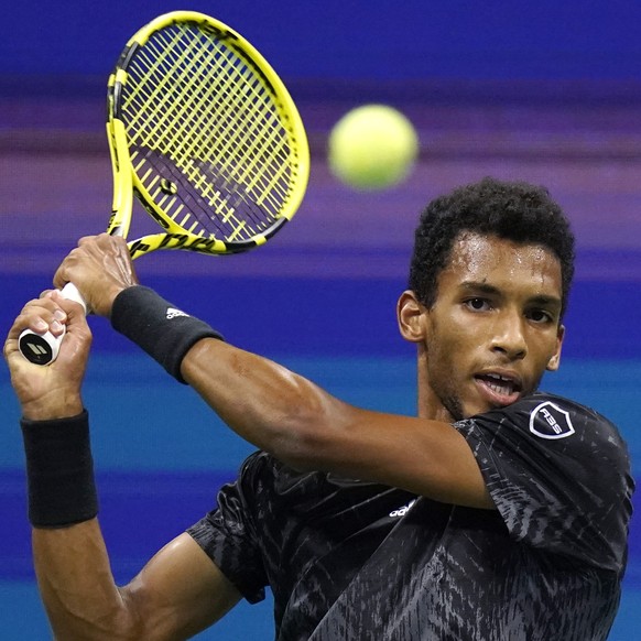 Felix Auger-Aliassime, of Canada, returns against Frances Tiafoe, of the United States, during the fourth round of the US Open tennis championships, Sunday, Sept. 5 2021, in New York. (AP Photo/Frank  ...