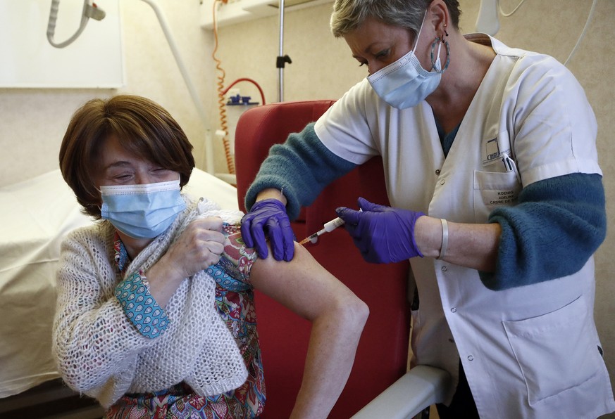 epa08919019 A health worker receives a dose of the Pfizer-BioNTech COVID-19 vaccine at Antoine Balmes hospital in Montpellier, France, 04 January 2021. It is part of the launch of the vaccination camp ...