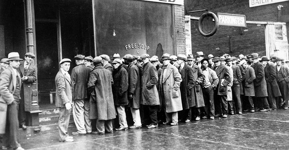 The Great Depression. Unemployed men queued outside a soup kitchen opened in Chicago by Al Capone. The storefront sign reads 'Free Soup, Coffee and Doughnuts for the Unemployed.' Chicago, 1930s (Newsc ...