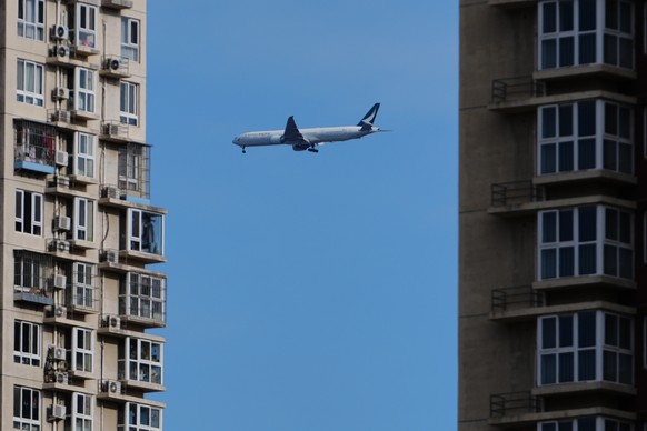 A Cathay Pacific airliner flies past residential buildings as it prepares to land at the Beijing Capital International Airport, in Beijing, Monday, Dec. 1, 2025. (AP Photo/Andy Wong)
China Daily Life