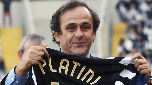 Former Juventus soccer star Michel Platini shows a commemorative jersey he received during a ceremony to mark Juventus&#039; 109-year history, prior to an Italian second division soccer match between  ...