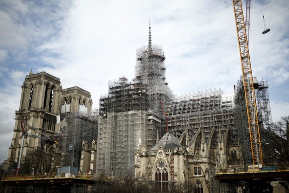 epa11150352 Reconstruction workers start to remove the scaffolding around the spire of Notre Dame in Paris, France, 13 February 2024. After the collapse of the spire in the 15 April 2019 Notre-Dame fi ...