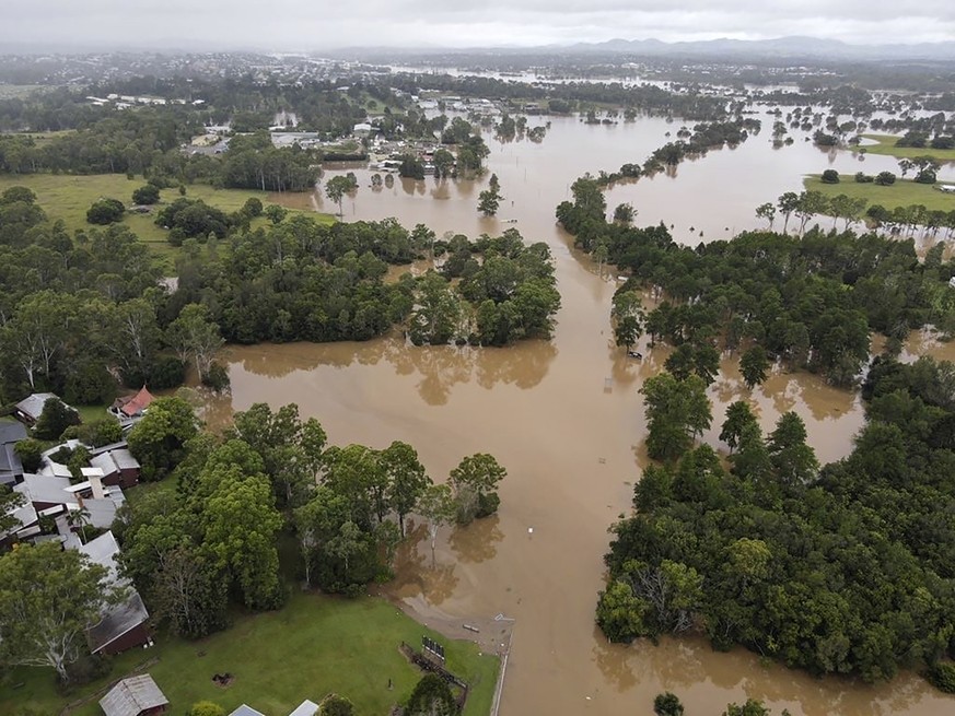 In this photo provided by the Queensland Fire and Emergency Services, water floods land and buildings near Gympie, north of Brisbane, Australia Sunday, Feb. 27, 2022. Heavy rain is bringing record flo ...