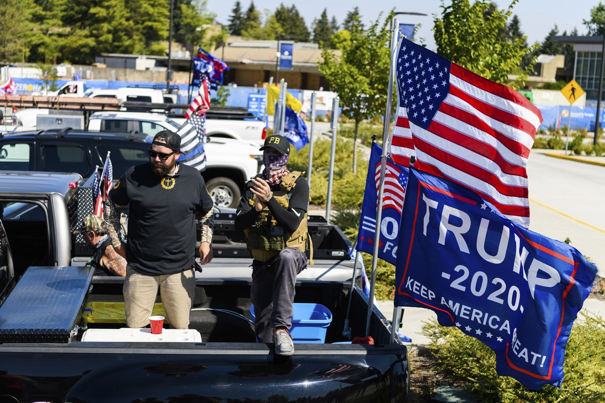 Proud Boy members who chose to remain anonymous listen to Patriot Prayer founder Joey Gibson speak during the "Oregon for Trump 2020 Labor Day Cruise Rally" at Clackamas Community College in ...