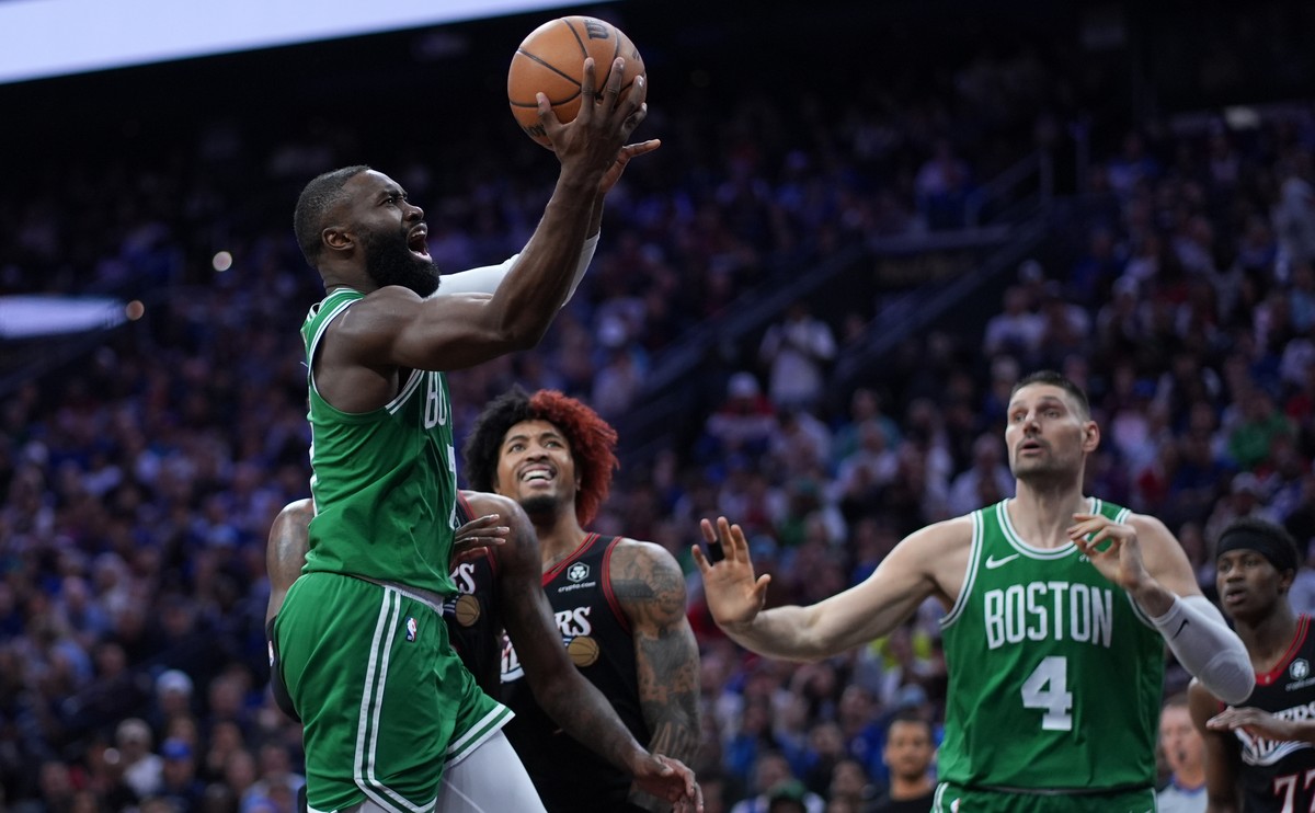 Boston Celtics' Jaylen Brown, left, goes up for a shot past Philadelphia 76ers' Kelly Oubre Jr. during the first half of Game 3 in a first-round NBA playoffs basketball series Friday, April  ...