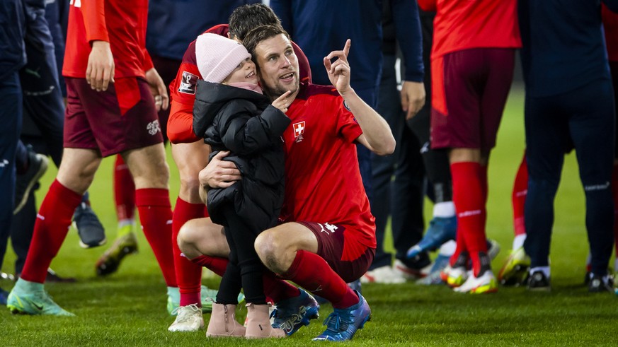 Switzerland's soccer players with Fabian Frei celebrate after directly qualifying for the FIFA World Cup Qatar 2022 during the 2022 FIFA World Cup European Qualifying Group C match between Switze ...