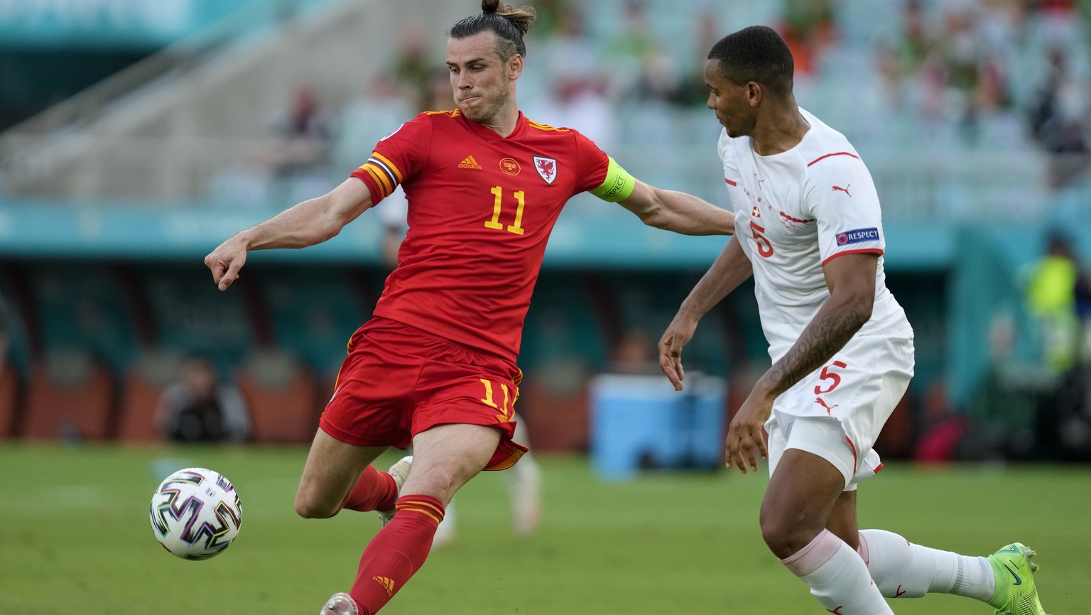 Wales&#039; Gareth Bale kicks the ball past Switzerland&#039;s Manuel Akanji during the Euro 2020 soccer championship group A match between Wales and Switzerland, at the Baku Olympic stadium, in Baku, ...