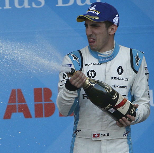 Second place winner Nio driver Oliver Turvey, left, and third place winner Renault driver Sebastien Buemi, spray champagne at champion Daniel Abt, of Audi Sport ABT Schaeffler, as they celebrate at th ...