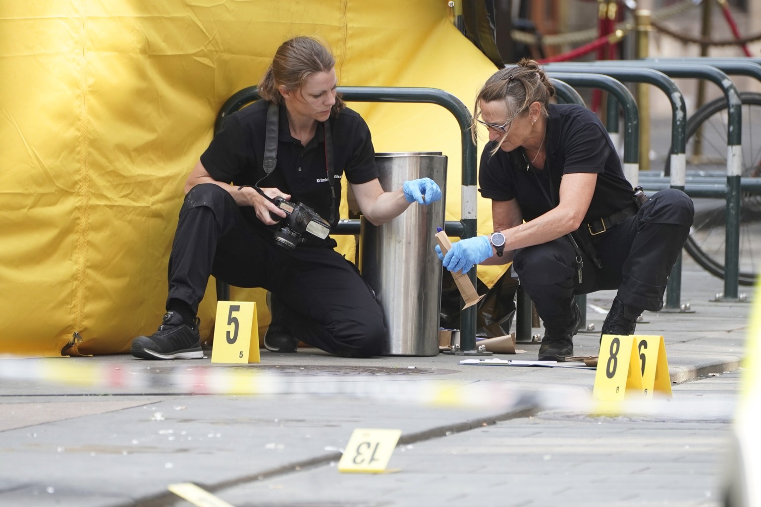 epa10033182 Police collect evidence at a crime scene in the aftermath of overnight shootings in the center of Oslo, Norway, 25 June 2022. Two people were killed and at least 20 were injured when a gun ...