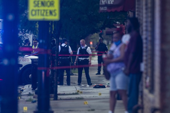 Chicago police investigate the scene of a mass shooting where more then a dozen people were shot in the Gresham neighborhood, of Chicago, Tuesday, July 21, 2020. (Tyler LaRiviere/Chicago Sun-Times via ...
