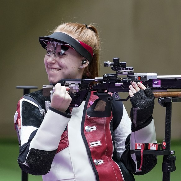 Nina Christen, of Switzerland, reacts after the last shot in the women's 50-meter 3 positions rifle at the Asaka Shooting Range in the 2020 Summer Olympics, Saturday, July 31, 2021, in Tokyo, Japan. C ...