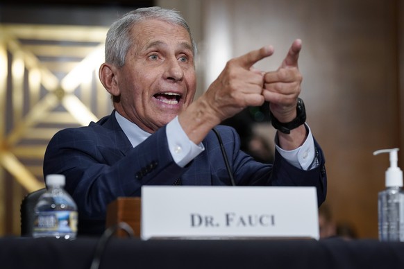 FILE - Dr. Anthony Fauci, director of the National Institute of Allergy and Infectious Diseases, responds to accusations by Sen. Rand Paul, R-Ky., as he testifies before the Senate Health, Education,  ...