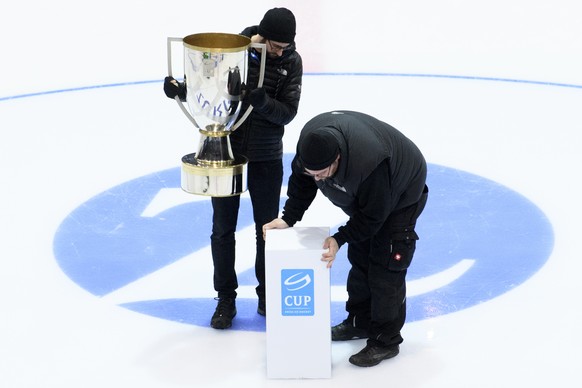 Technical staff members set up the Swiss Ice Hockey Cup Trophy before the Swiss Ice Hockey Cup final game between EHC Kloten and Geneve-Servette HC, at the SWISS Arena ice stadium, in Kloten, Wednesda ...