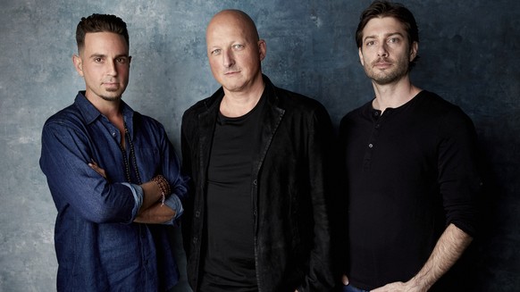 FILE - In this Jan. 24, 2019, file photo, Wade Robson, from left, director Dan Reed and James Safechuck pose for a portrait to promote the film &quot;Leaving Neverland&quot; during the Sundance Film F ...