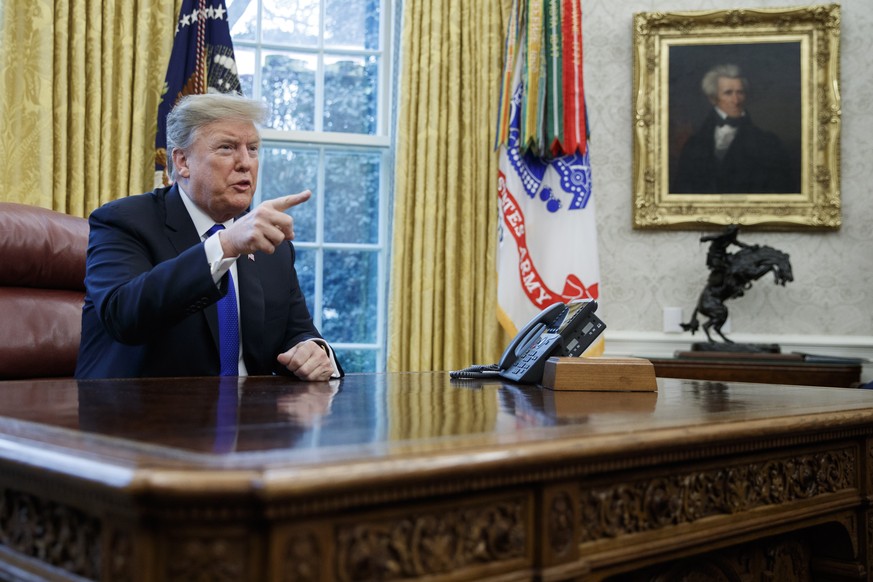 epa07388911 US President Donald J. Trump responds to a question from the news media during a meeting in the Oval Office of the White House in Washington, DC, USA 22 January 2019. The US and China are  ...