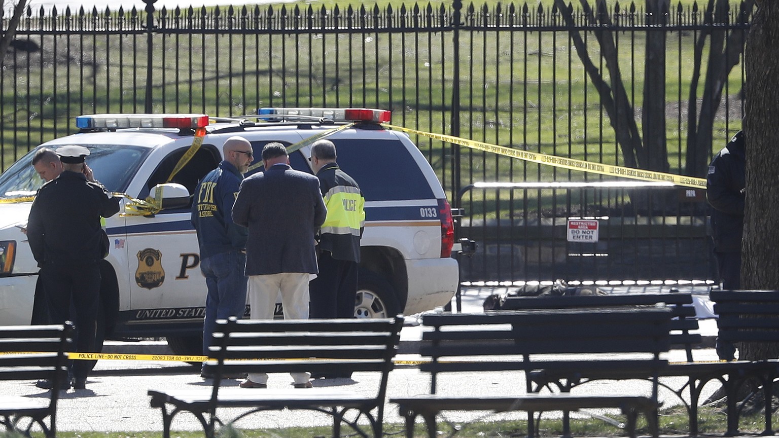 Law enforcement officers gather in front of the White House in Washington, after the area was closed to pedestrian traffic, Saturday, March 3, 2018. Authorities said a man shot himself to death outsid ...