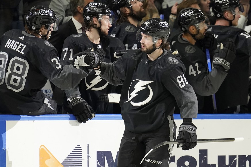 Tampa Bay Lightning right wing Nikita Kucherov (86) celebrates with the bench after scoring against the Winnipeg Jets during the third period of an NHL hockey game Saturday, April 16, 2022, in Tampa,  ...
