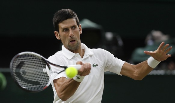 Serbia&#039;s Novak Djokovic returns the ball to Rafael Nadal of Spain during their men&#039;s singles semifinals match at the Wimbledon Tennis Championships, in London, Friday July 13, 2018.(AP Photo ...