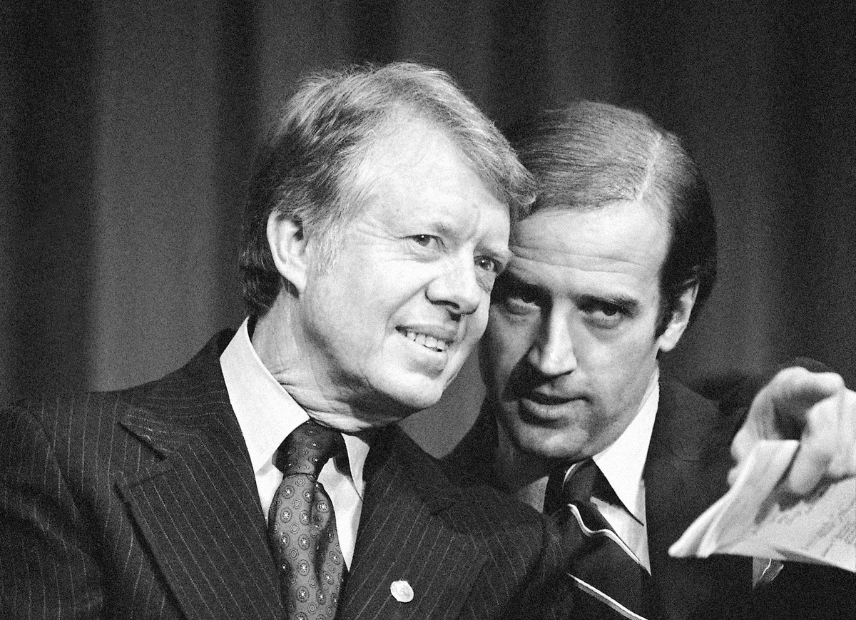 FILE - In this Feb. 20, 1978, file photo, President Jimmy Carter listens to Sen. Joseph R. Biden, D-Del., as they wait to speak at fund raising reception at Padua Academy in Wilmington, Del. President ...