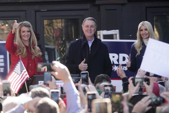 Sen. Kelly Loeffler, R-Ga., left, stands with Sen. David Perdue, R-Ga., and Ivanka Trump, Assistant to the President, during a campaign rally, Monday, Dec. 21, 2020, in Milton, Ga. (AP Photo/John Baze ...