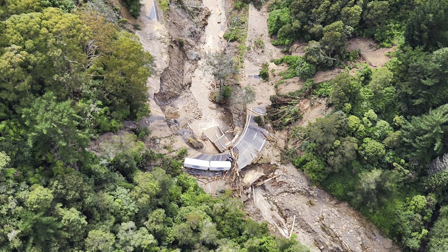 In this image released by the New Zealand Defense Force on Wednesday, Feb. 15, 2023, a road between Napier and Wairoa is washed out by flood water. The New Zealand government declared a national state ...