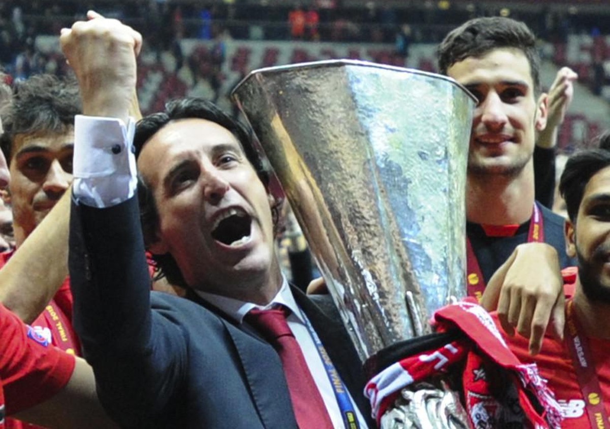 Sevilla's head coach Unai Emery holds the trophy after Sevilla won 3-2 during the final of the soccer Europa League between FC Dnipro Dnipropetrovsk and Sevilla FC at the National Stadium in Wars ...