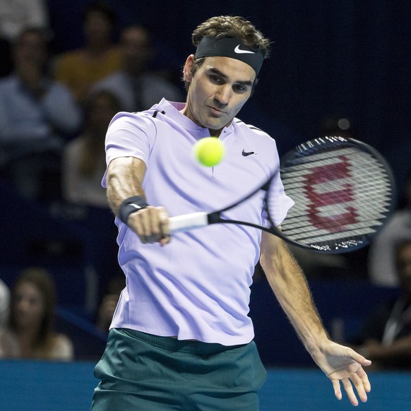 Switzerland&#039;s Roger Federer returns a ball to Belgium&#039;s David Goffin during their semifinal match at the Swiss Indoors tennis tournament at the St. Jakobshalle in Basel, Switzerland, on Satu ...