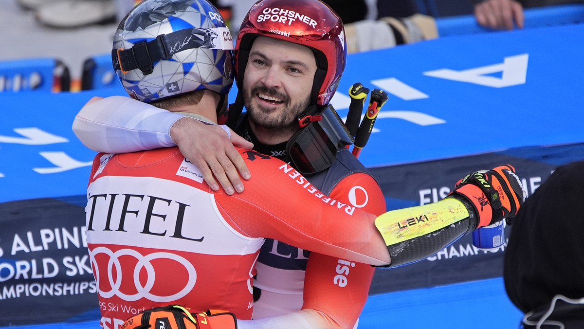 First place finisher Switzerland's Marco Odermatt, left, embraces second place finisher Switzerland's Loic Meillard after a men's World Cup giant slalom skiing race Saturday, March 2, 2 ...
