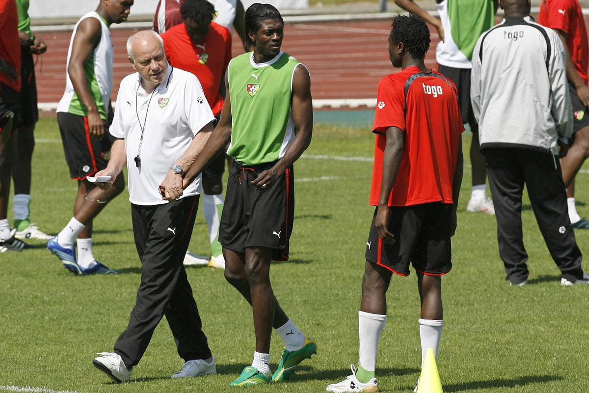 Togo's Emmanuel Adebayor, second left, and Otto Pfister, left, German coach of the Togolese national soccer team, walk over the pitch hand in hand during a training session in Wangen, Germany, on ...