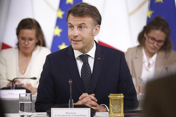 French President Emmanuel Macron chairs a meeting with representatives of the sectors affected by new tariffs announced by President Donald Trump, Thursday, April 3, 2025 at the Elysee Palace in Paris ...