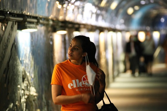 Italy , Return to normality for Summer Holidays. A small reportage in Cinque Terre Bay : a women takes off her mask in the Via dell amore Love Road during the Light Lockdown of the Covid 19 Coronaviru ...