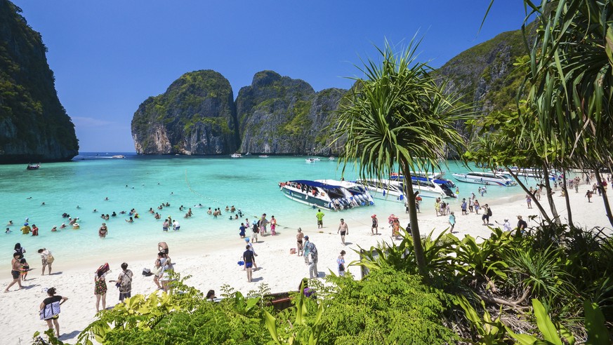 In this March 4, 2017, photo, tourists enjoy the popular Maya bay on Phi Phi island, Krabi province. Authorities have ordered the temporary closing of the beach made famous by the Leonardo DiCaprio mo ...