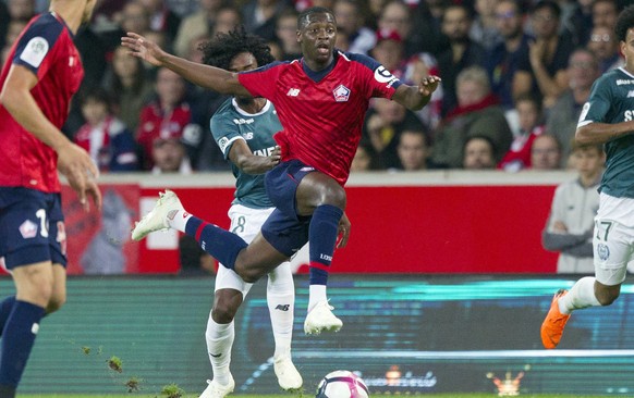 FILE - In this Saturday, Sept. 22, 2018 file photo, Lille&#039;s Nicolas Pepe, center, controls the ball during the French League One soccer match against Nantes at the Lille Metropole stadium, in Vil ...