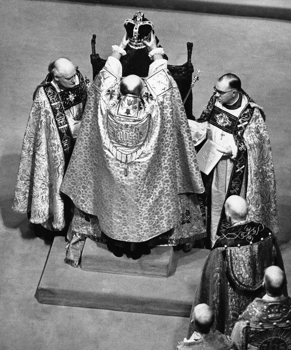 FILE - The Archbishop of Canterbury holds the ritual crown of England, the crown of St. Edward, over the head of Queen Elizabeth II, prior to the actual crowning at the coronation ceremony in Westmins ...