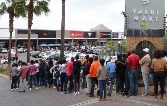 epa07184007 Members of the public stand in a long queue as they wait to shop at department stores in the Woodmead Value mart during Black Friday in Johannesburg, South Africa, 23 November 2018. EPA/KI ...