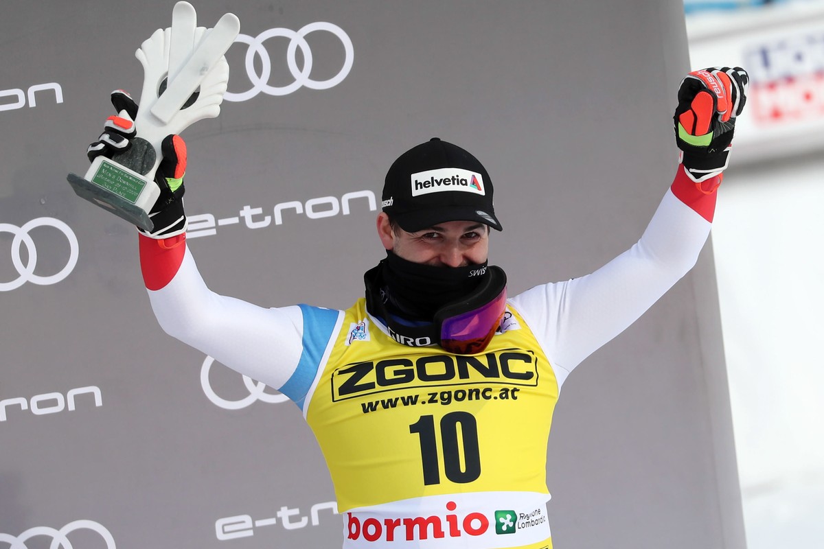 epa08911251 Third placed Urs Kryenbuehl of Switzerland celebrates on the podium after the Men's Downhill race at the FIS Alpine Skiing World Cup event in Bormio, Italy, 30 December 2020. EPA/ANDR ...