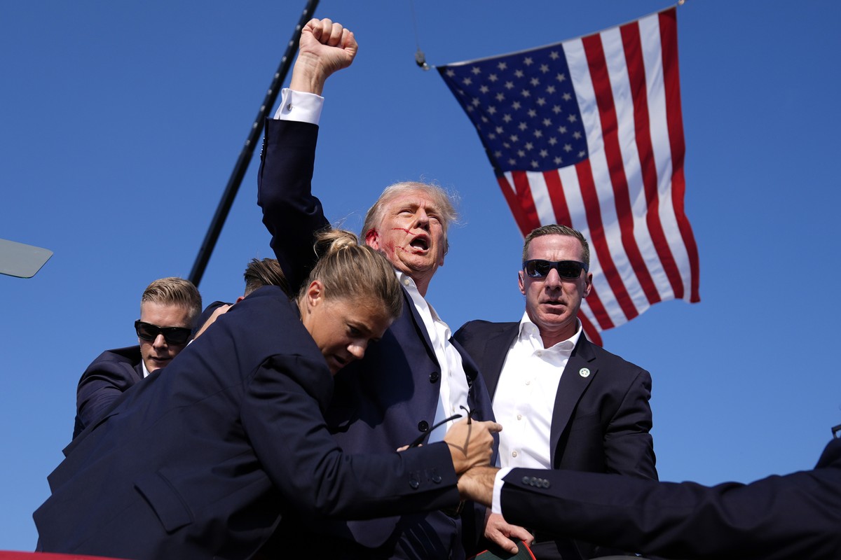 FILE - Republican presidential candidate former President Donald Trump is surrounded by U.S. Secret Service agents after an assassination attempt at a campaign rally in Butler, Pa., July 13, 2024. (AP ...