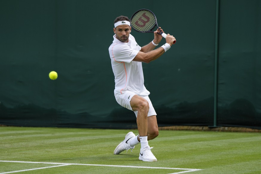 Bulgaria&#039;s Grigor Dimitrov plays a return to Japan&#039;s Sho Shimabukuro during the singles match on day three of the Wimbledon tennis championships in London, Wednesday, July 5, 2023. (AP Photo ...