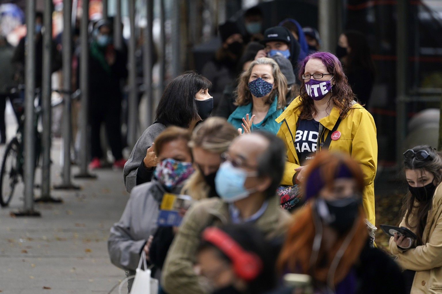 People wait in line at an early voting site in New York, Tuesday, Oct. 27, 2020. New Yorkers lined up to vote early for a fourth consecutive day Tuesday after a weekend that saw a crush of more than 4 ...