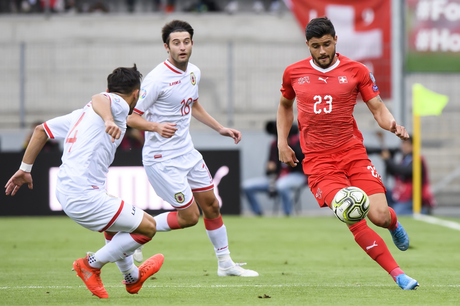 Switzerland&#039;s midfielder Loris Benito, right, fights for the ball with Gibraltar&#039;s defender John Sergeant, left, and Gibraltar&#039;s midfielder Anthony Hernandez, center, during the UEFA Eu ...