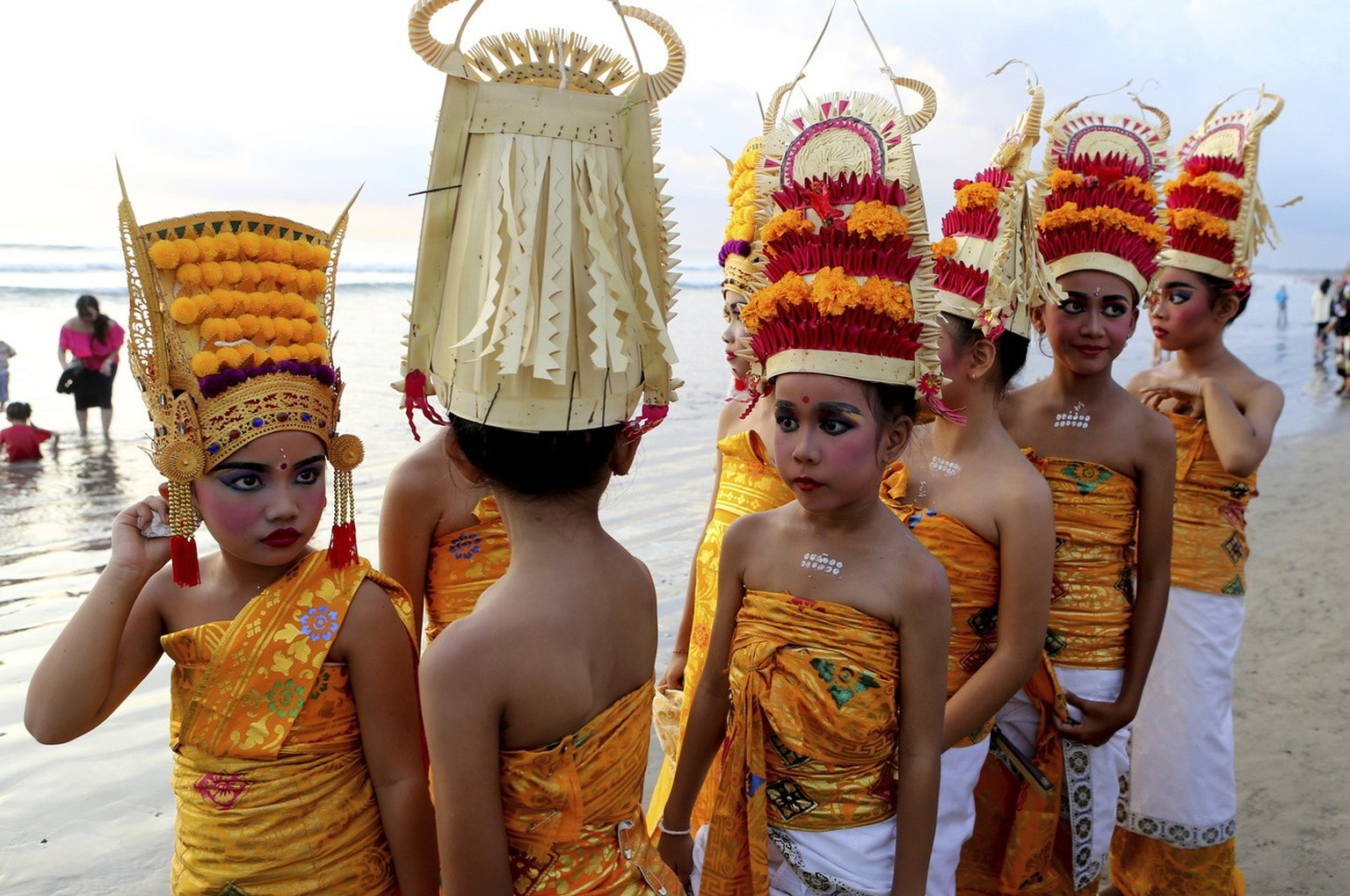 Children in traditional clothing walk during the Melasti, a purification ceremony on the beach of Kuta, Bali, Indonesia, on Sunday, March 19, 2023.  The ritual, which is performed prior to the Balinese Hindus…