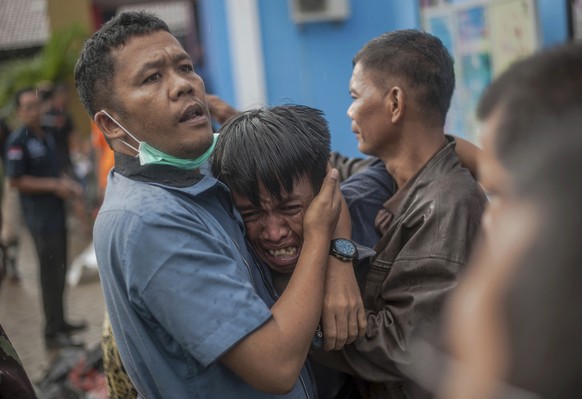 A man reacts after identifying his relative among the bodies of tsunami victims in Carita, Indonesia, Sunday, Dec. 23, 2018. The tsunami occurred after the eruption of a volcano around Indonesia&#039; ...